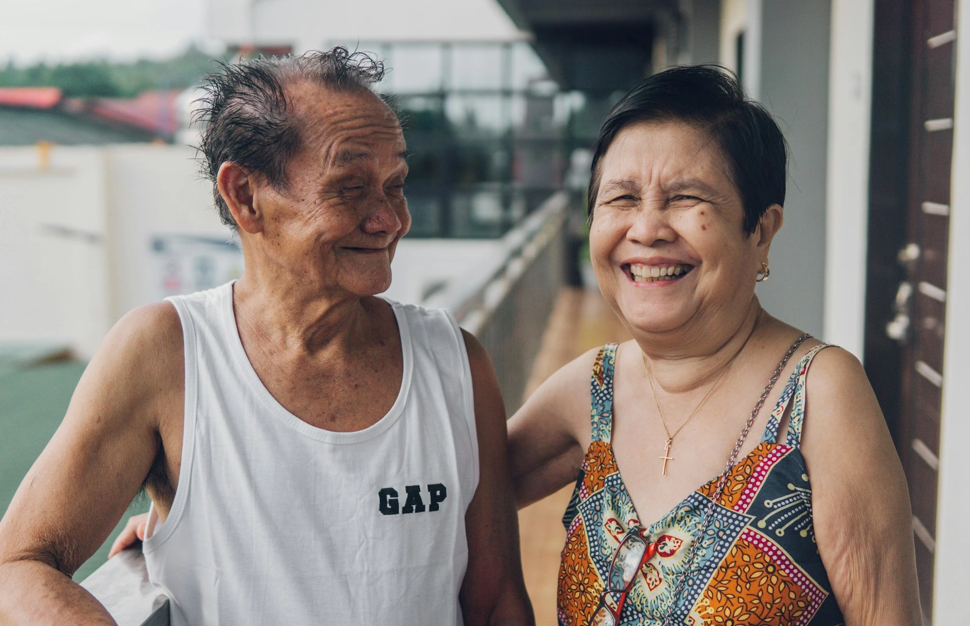 Karen's parents, a smiling senior couple, sharing a warm moment together at home
